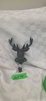 Front view of cast iron deer head hook showing antlers and hook