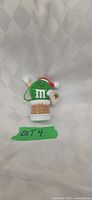 Front view of green M&M Santa ornament