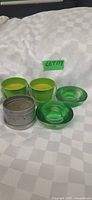 All items grouped: three green metal pails, two green glass dishes, silver metal tin