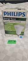 Front of boxed Philips Energy Saver R30 flood bulb showing wattage and outdoor rating