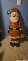 Full view of woven tinsel Santa with power cord