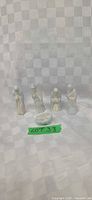 Five ceramic Nativity figures on checked backdrop
