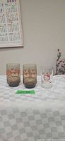 Two smokey Canada glasses and Hello Kitty tumbler on table