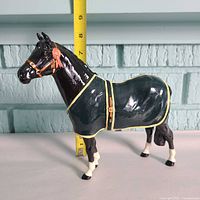 Full left side view of Beswick Welsh Mountain Pony figurine with ruler for scale