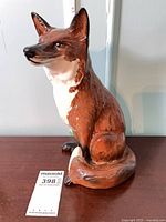 Full view of seated Beswick fireside fox figurine with measurement scale