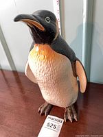 Front view of Beswick model 2357 penguin figurine with measuring tape indicating height