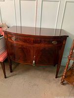 Full view of mahogany bow front hutch