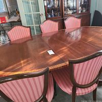 Oval cherry dining table with chairs around