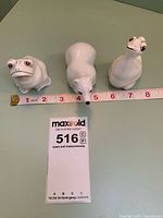 All three Coalport figurines with tape measure indicating size