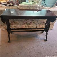 Front view of dark wood console table with leaves down