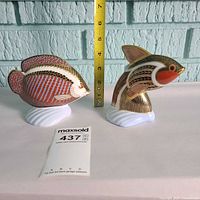 Two Royal Crown Derby fish paperweights with ruler for scale
