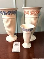 Group shot of three Wedgwood vases showing sizes and relief colours