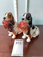 Both Royal Doulton spaniel figurines front view with scale