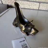 Left-side view of brass Scottish terrier pipe rest showing overall form