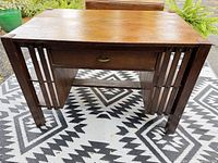 Front view showing top, drawer, slat sides