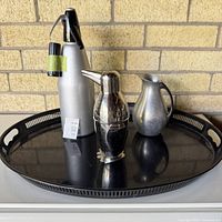 Overall shot: tray holding siphon, penguin shaker, jug