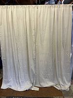 Full view of both curtain panels hanging to show size and color