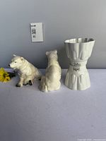 Front view of two polar bear figurines with one Shelley jelly mold upright