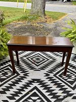 Closed wooden piano bench front view