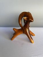 Front view of stylized brown majolica ram figurine