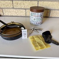 Group view of ashtray, tobacco caddy, tools, instruction sheet