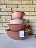 Stacked view of all four nesting bowls showing exterior colours and sizes.