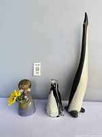 Front view of all three items: Daniel Martineau penguin, art glass penguin, KIC vase