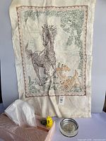 All four items together: tissue box cover, tea towel, glass dish, partial view of frame