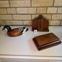 All three items: pair of bookends, duck decoy, lidded box