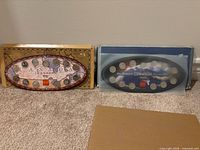 Both 1999 and 2000 oval coin sets in packaging