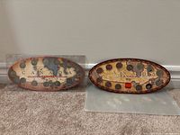 Both oval coin sets side-by-side showing fronts
