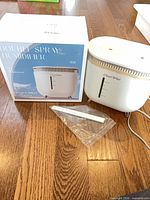Boxed H56 humidifier beside unboxed unit, accessories visible