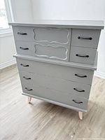 Front view showing all five drawers and hardware