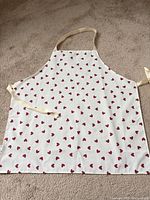 Full view of apron showing heart pattern, straps, and overall condition