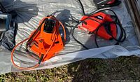 Alligator Lopper and chainsaw on plastic sheeting outdoors
