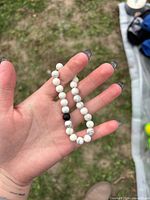 Bracelet shown in hand to indicate bead size and colour