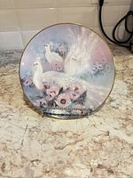 Front of the decorative plate showing white peacocks scene