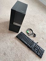 Front and top view of Dell OptiPlex 5070 tower with keyboard and cable