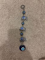 Full view of hanging decoration with elephants and evil-eye beads