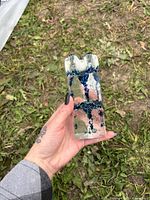 Single clear and blue glass candle holder held in hand