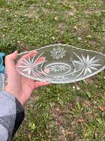 Top view of oval glass dish showing starburst pattern and scalloped rim