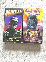 Front view of both VHS tapes showing artwork and titles