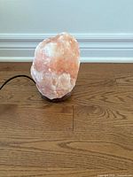 Front view of Himalayan salt rock lamp on wooden base