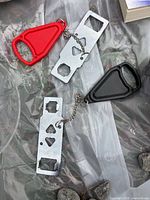 Top view of both portable door locks showing steel plates, cut-outs, chains and red/black inserts
