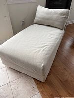 Full view of beige upholstered chaise lounge