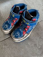 Top view of both shoes showing design, straps, character names