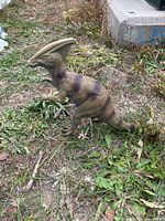 Parasaurolophus dinosaur figure standing on grass