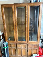 Full view of china cabinet showing glass upper doors and wood lower doors