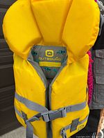 Yellow Outbound infant life jacket front view showing collar and straps