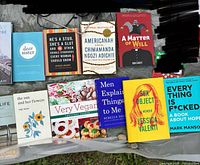 Group of fourteen books laid out on tarp